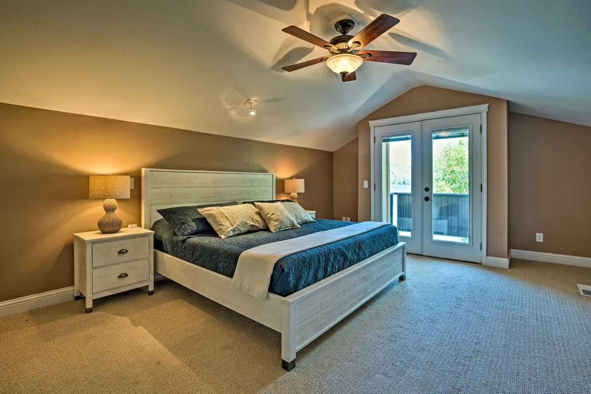 Primary bedroom with balcony doors