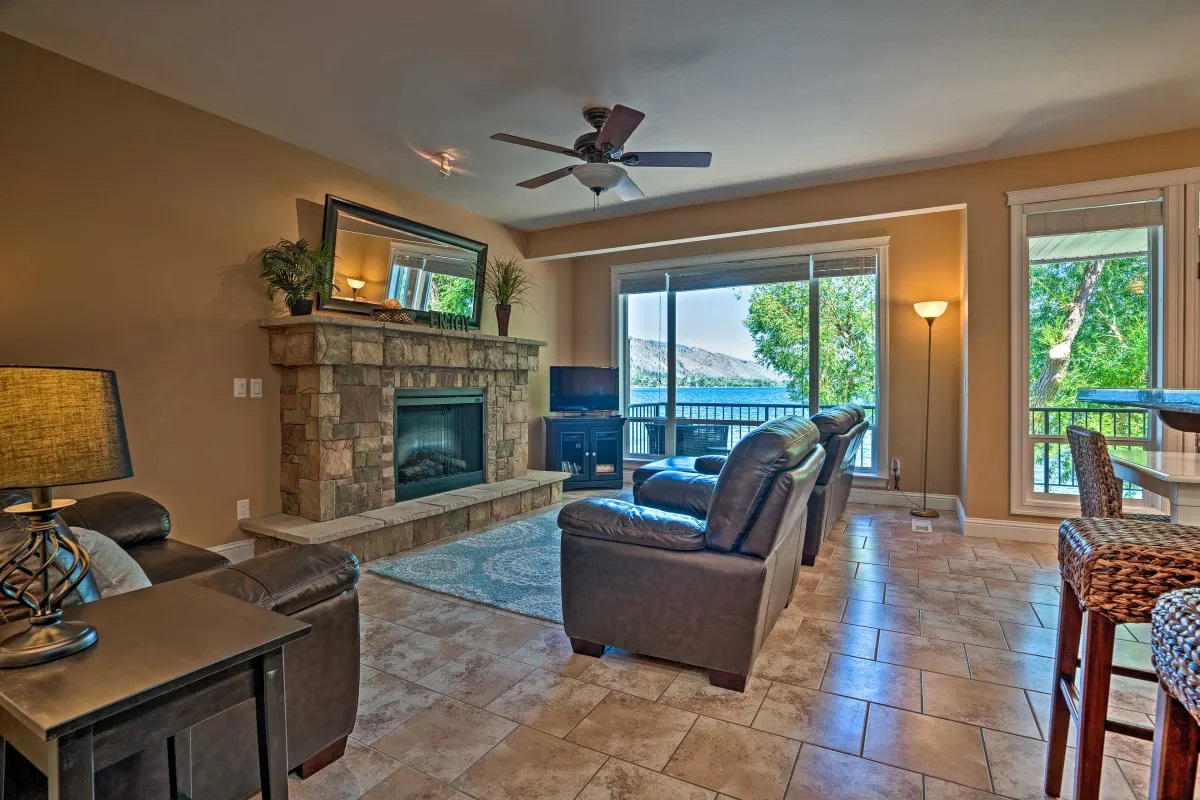 Main living room with stone fireplace and lake view